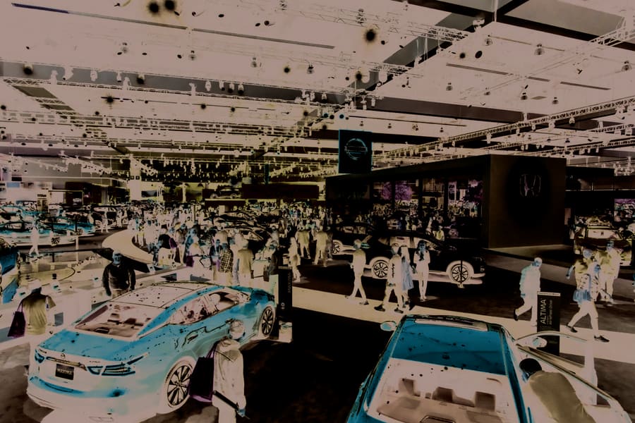 Automotive showroom floor with vehicles on display, retail and logistics sourcing