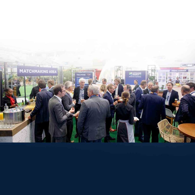 Business professionals networking at a Matchmaking Area during a trade exhibition
